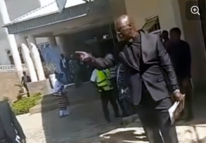 Screenshot from a video posted by Jay FM shows a Church of Christ in Nations (COCIN) leader following the dispute outside the church headquarters in Jos during the funeral service.